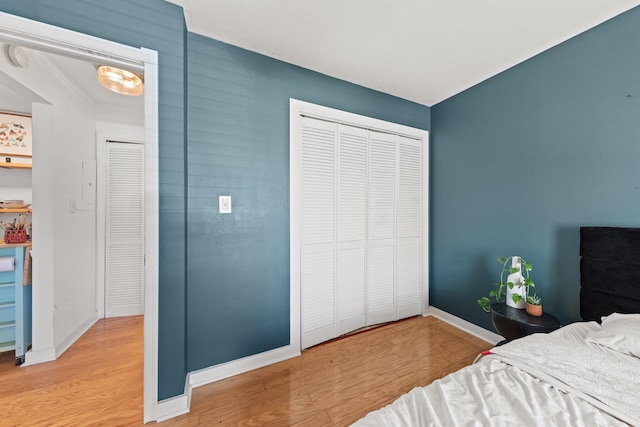 bedroom with wood finished floors and baseboards
