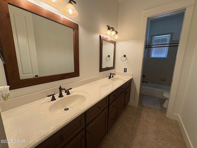 5303 Hopetown Ln, Panama City Beach, FL 32408 - full bath with tile patterned floors, double vanity, toilet, baseboards, and  shower combination