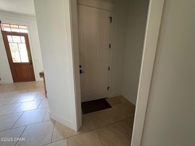 5303 Hopetown Ln, Panama City Beach, FL 32408 - foyer featuring baseboards, light tile patterned floors, and ornamental molding