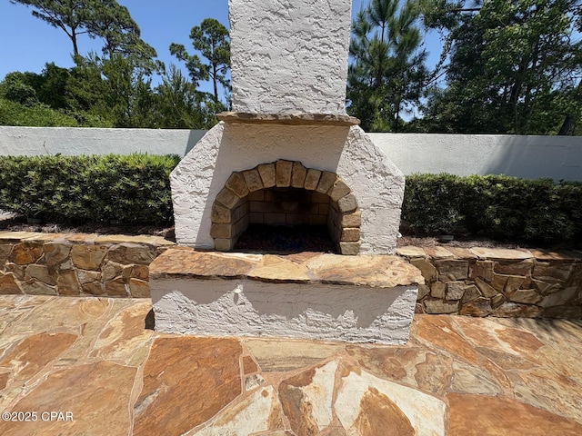 5303 Hopetown Ln, Panama City Beach, FL 32408 - view of patio / terrace with an outdoor stone fireplace and a fenced backyard