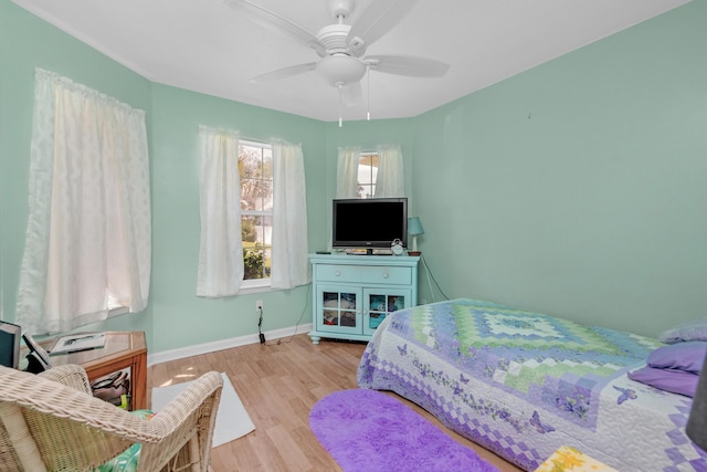 102 Wright Dr, Niceville, FL 32578 - bedroom with wood finished floors, baseboards, and a ceiling fan