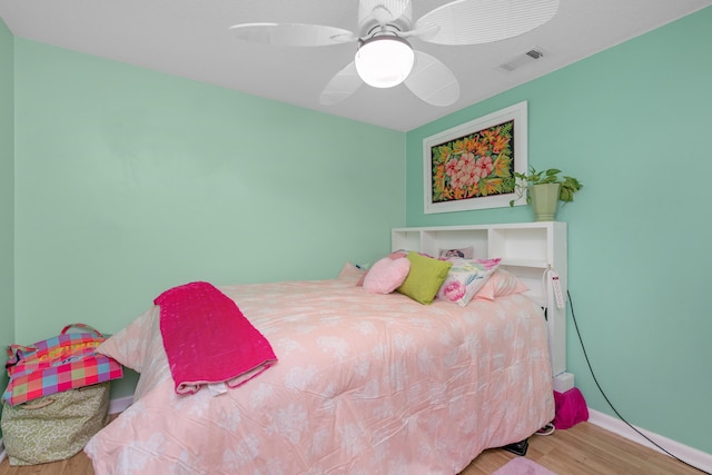 102 Wright Dr, Niceville, FL 32578 - bedroom featuring wood finished floors, a ceiling fan, and baseboards