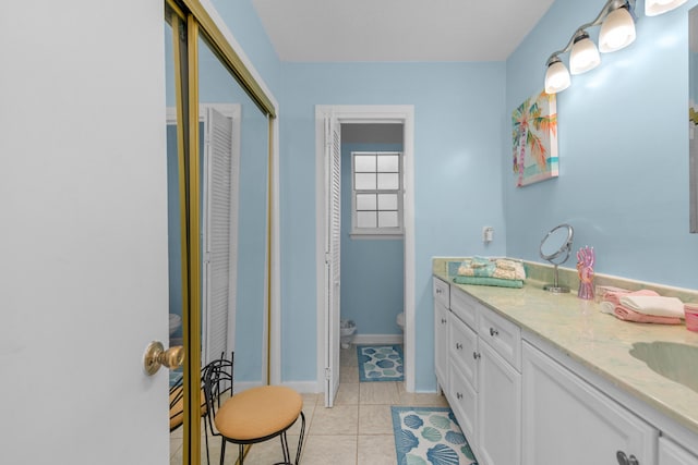 102 Wright Dr, Niceville, FL 32578 - bathroom featuring toilet, double vanity, tile patterned flooring, and a closet