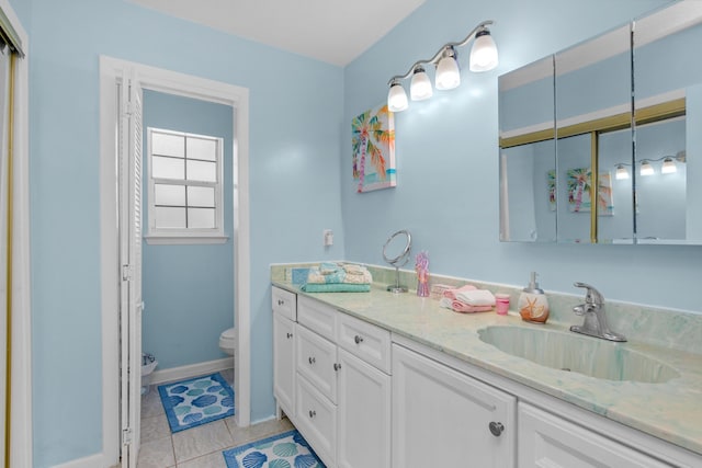 102 Wright Dr, Niceville, FL 32578 - full bathroom featuring toilet, double vanity, tile patterned flooring, and baseboards