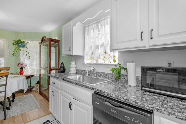102 Wright Dr, Niceville, FL 32578 - kitchen featuring dishwasher, a sink, and white cabinetry