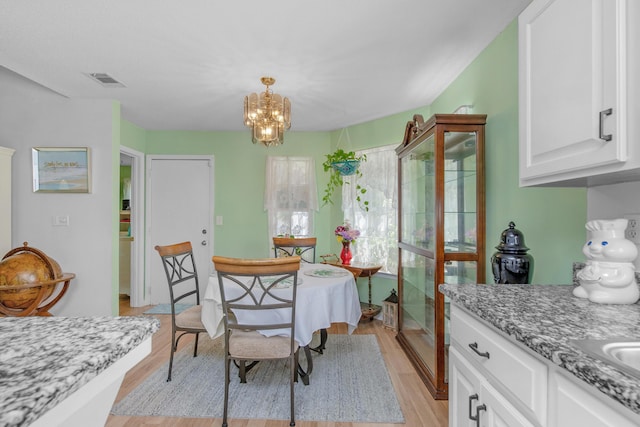 102 Wright Dr, Niceville, FL 32578 - dining space featuring a chandelier and light wood-style flooring