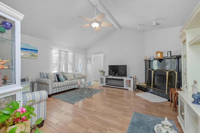 102 Wright Dr, Niceville, FL 32578 - living room featuring beamed ceiling, a ceiling fan, light wood-style flooring, a fireplace, and high vaulted ceiling