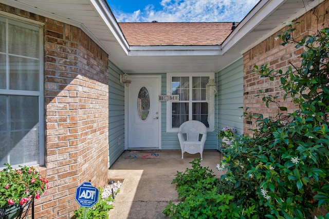 102 Wright Dr, Niceville, FL 32578 - property entrance featuring roof with shingles and brick siding