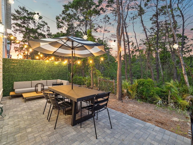 190 Valdare Ln, Inlet Beach, FL 32461 - patio terrace at dusk with outdoor dining space and an outdoor living space