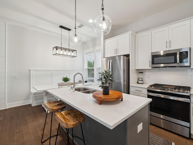190 Valdare Ln, Inlet Beach, FL 32461 - kitchen featuring stainless steel appliances, a sink, backsplash, a kitchen island with sink, and dark wood finished floors
