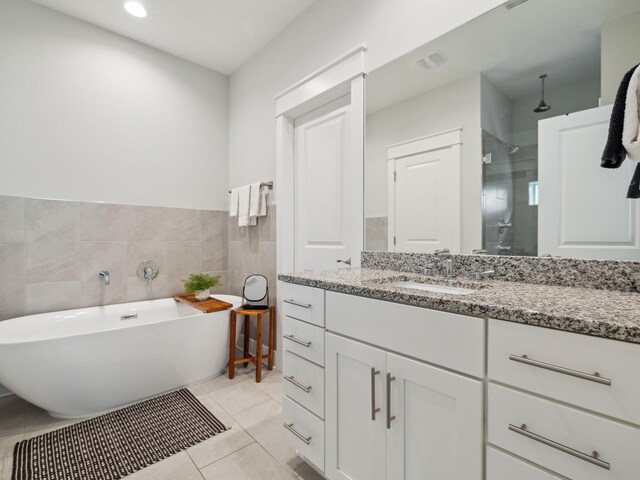 190 Valdare Ln, Inlet Beach, FL 32461 - full bath featuring vanity, a soaking tub, tiled shower, tile walls, and a wainscoted wall