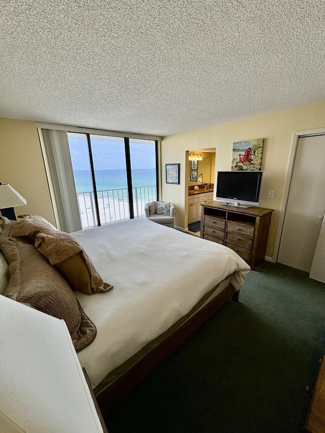 11347 Front Beach Rd # 601, Panama City Beach, FL 32407 - bedroom with a textured ceiling, access to outside, and dark carpet