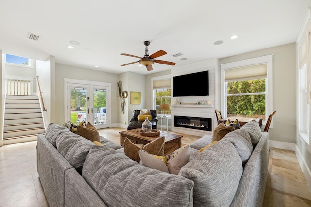241 Overlook Dr, Miramar Beach, FL 32550 - living room with french doors, a fireplace, stairway, baseboards, and a ceiling fan