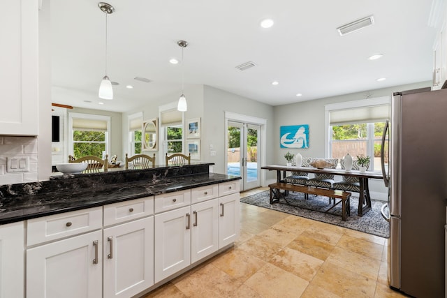 241 Overlook Dr, Miramar Beach, FL 32550 - kitchen with freestanding refrigerator, plenty of natural light, white cabinetry, and recessed lighting