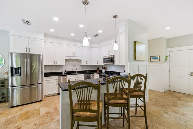 241 Overlook Dr, Miramar Beach, FL 32550 - kitchen with stainless steel appliances, a sink, dark countertops, decorative backsplash, and white cabinetry