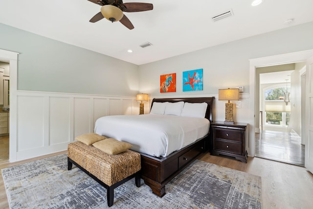 241 Overlook Dr, Miramar Beach, FL 32550 - bedroom with wood finished floors, a wainscoted wall, a decorative wall, a ceiling fan, and recessed lighting