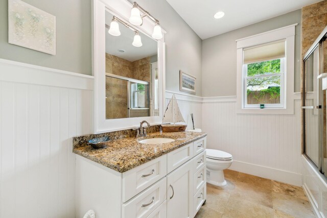 241 Overlook Dr, Miramar Beach, FL 32550 - full bathroom featuring wainscoting, a shower with shower door, toilet, vanity, and tile patterned flooring