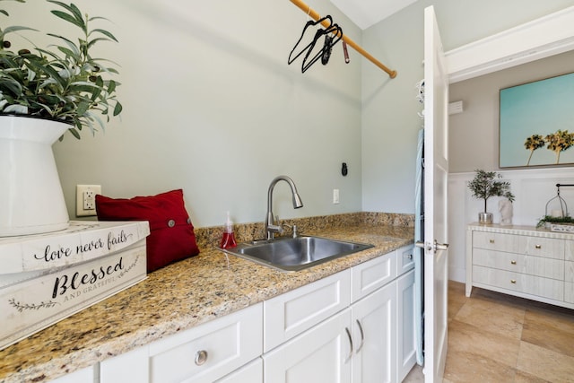 241 Overlook Dr, Miramar Beach, FL 32550 - kitchen featuring a sink, white cabinetry, and light stone finish flooring