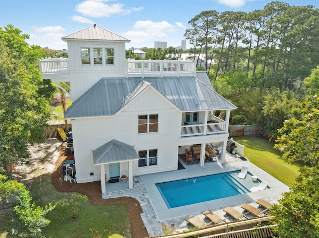 241 Overlook Dr, Miramar Beach, FL 32550 - rear view of property featuring a balcony, a patio area, an outdoor pool, metal roof, and a standing seam roof
