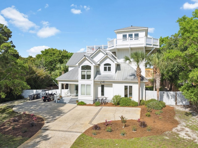 241 Overlook Dr, Miramar Beach, FL 32550 - view of front of home featuring a porch, fence, a balcony, and concrete driveway