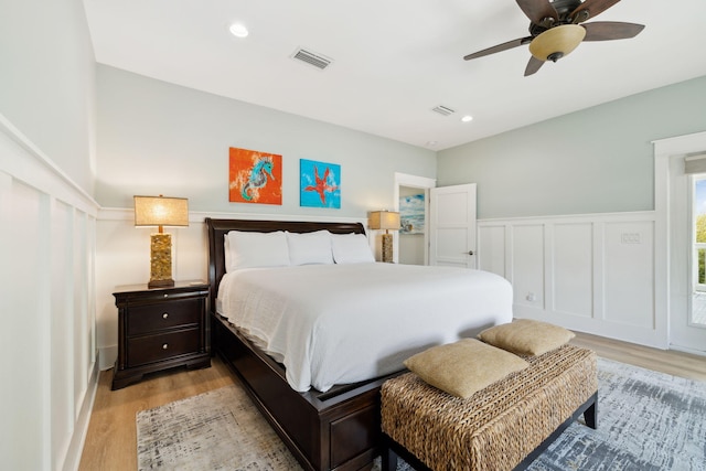 241 Overlook Dr, Miramar Beach, FL 32550 - bedroom featuring light wood-type flooring, ceiling fan, wainscoting, recessed lighting, and a decorative wall