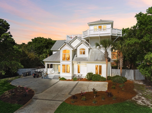 241 Overlook Dr, Miramar Beach, FL 32550 - view of front of property with a porch, a balcony, fence, and concrete driveway