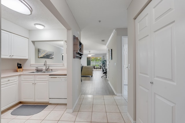 4274 Calinda Ln Unit 225, Niceville, FL 32578 - kitchen featuring white dishwasher, a sink, white cabinets, light tile patterned floors, and light countertops
