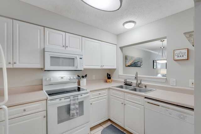 4274 Calinda Ln Unit 225, Niceville, FL 32578 - kitchen with white appliances, a sink, white cabinets, a textured ceiling, and light countertops
