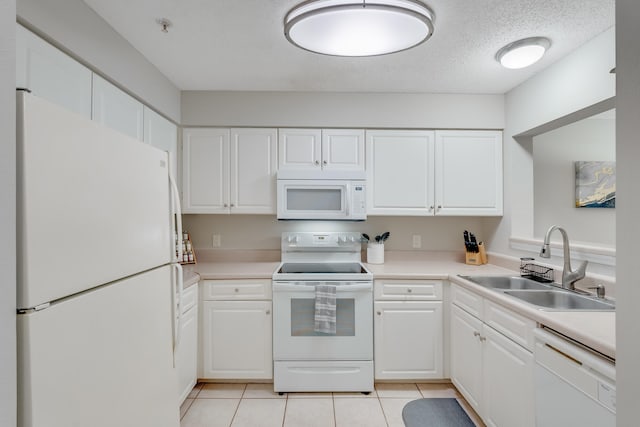 4274 Calinda Ln Unit 225, Niceville, FL 32578 - kitchen featuring white appliances, a sink, white cabinets, light tile patterned floors, and light countertops
