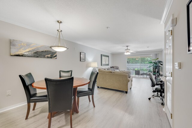 4274 Calinda Ln Unit 225, Niceville, FL 32578 - dining area with light wood finished floors, ornamental molding, a ceiling fan, baseboards, and a textured ceiling