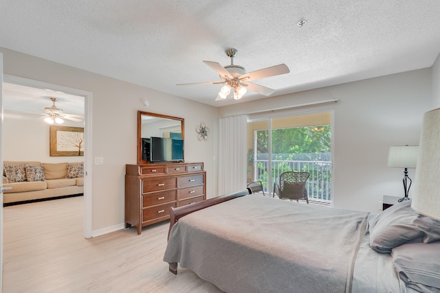 4274 Calinda Ln Unit 225, Niceville, FL 32578 - bedroom featuring access to outside, light wood-style floors, a textured ceiling, ceiling fan, and baseboards