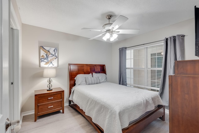 4274 Calinda Ln Unit 225, Niceville, FL 32578 - bedroom with light wood-style floors, baseboards, and ceiling fan