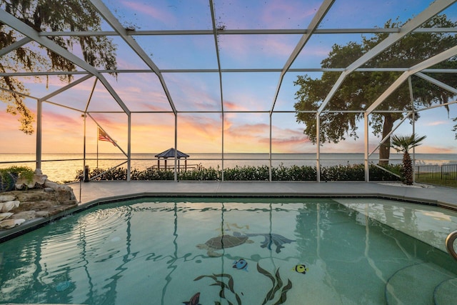 411 Calhoun Ave, Destin, FL 32541 - pool at dusk with a water view, a patio area, and a lanai