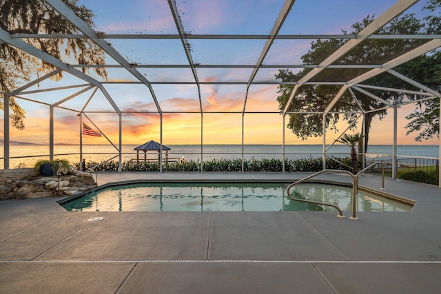 411 Calhoun Ave, Destin, FL 32541 - pool at dusk featuring a patio, an outdoor pool, and a water view