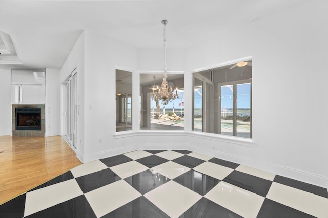 411 Calhoun Ave, Destin, FL 32541 - unfurnished dining area featuring a chandelier, a fireplace, and baseboards