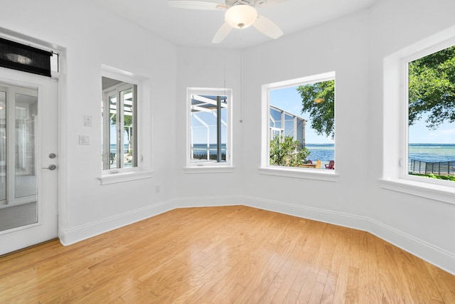 411 Calhoun Ave, Destin, FL 32541 - empty room with light wood-style flooring, baseboards, a water view, and ceiling fan