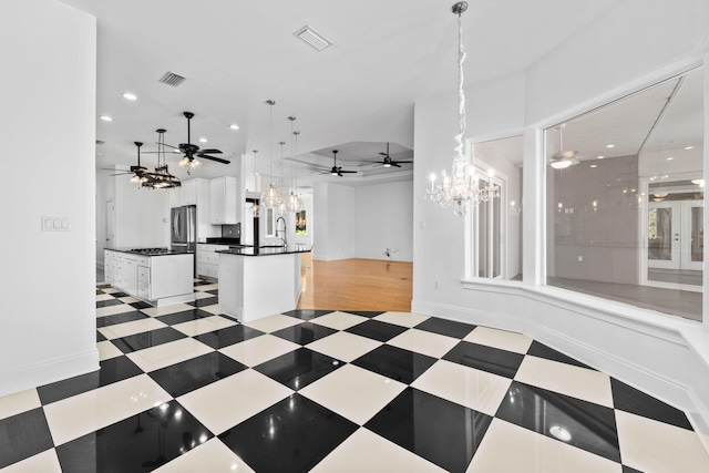 411 Calhoun Ave, Destin, FL 32541 - kitchen featuring open floor plan, a chandelier, dark countertops, a ceiling fan, and white cabinets