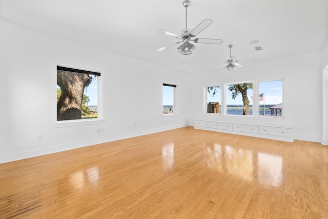 411 Calhoun Ave, Destin, FL 32541 - unfurnished living room featuring a ceiling fan, light wood-style flooring, and baseboards