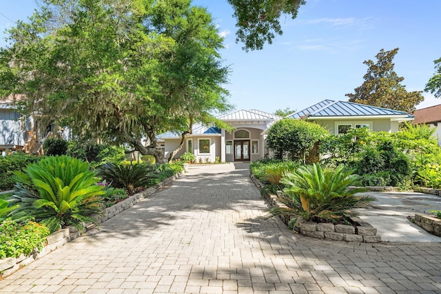 411 Calhoun Ave, Destin, FL 32541 - view of front of house with french doors, a standing seam roof, metal roof, and stucco siding