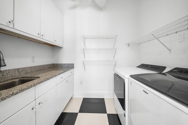 411 Calhoun Ave, Destin, FL 32541 - laundry room with washing machine and dryer, cabinet space, tile patterned floors, and baseboards