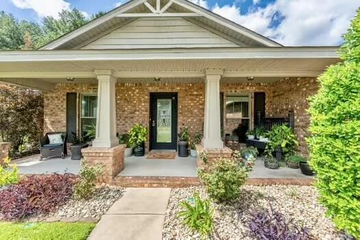 5930 Wind Trace Rd, Crestview, FL 32536 - property entrance with a porch and brick siding