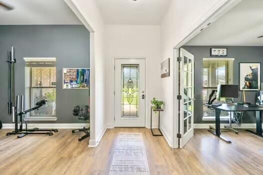 5930 Wind Trace Rd, Crestview, FL 32536 - doorway to outside featuring wood finished floors, an office area, baseboards, and french doors