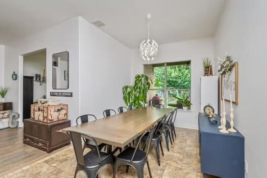 5930 Wind Trace Rd, Crestview, FL 32536 - dining space featuring a chandelier