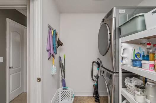5930 Wind Trace Rd, Crestview, FL 32536 - laundry room with stacked washer / dryer and baseboards