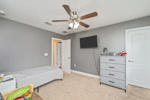 5930 Wind Trace Rd, Crestview, FL 32536 - bedroom with light carpet, baseboards, and a ceiling fan