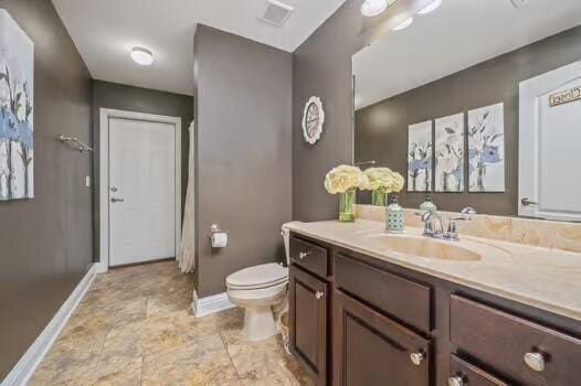 5930 Wind Trace Rd, Crestview, FL 32536 - bathroom with baseboards, toilet, and vanity