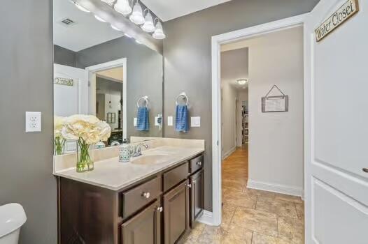5930 Wind Trace Rd, Crestview, FL 32536 - bathroom featuring vanity, toilet, and baseboards