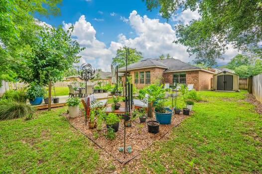 5930 Wind Trace Rd, Crestview, FL 32536 - view of yard with a storage unit and an outbuilding