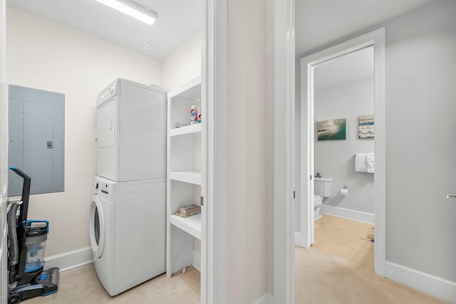 1653 W County Highway 30a Unit 1109, Santa Rosa Beach, FL 32459 - laundry area featuring electric panel, stacked washer / dryer, baseboards, and light carpet