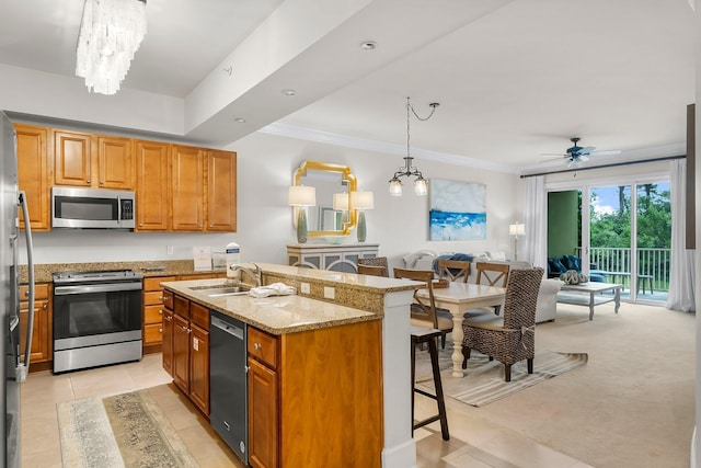 1653 W County Highway 30a Unit 1109, Santa Rosa Beach, FL 32459 - kitchen with appliances with stainless steel finishes, a sink, a kitchen bar, open floor plan, and light stone countertops